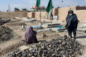 Zarmina's parents at her grave. She was an poet who died after setting herself on fire. Photo by Seasmus Murphy, 2012, Courtesy  of the Pulitzer Center on Crisis Reporting
